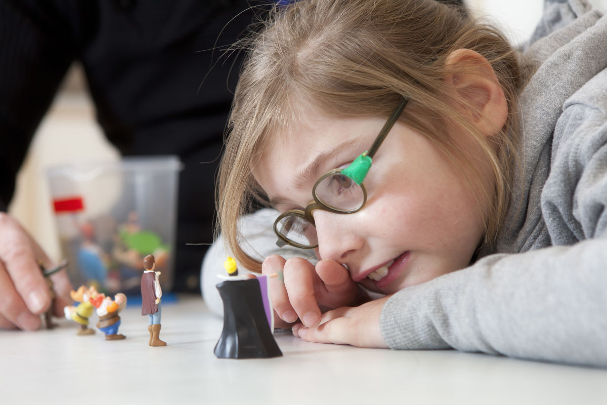 leerlinge-kijkt-naar-mini-figuurtjes