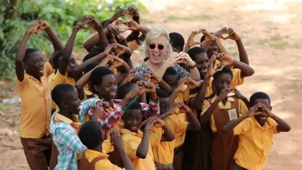 Kids in Africa and woman forming hears with their hands Kids in Africa and woman forming hears with their hands