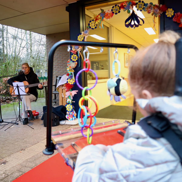 Kindje kijkt naar een docent die muziek maakt. Kindje kijkt naar een docent die muziek maakt.